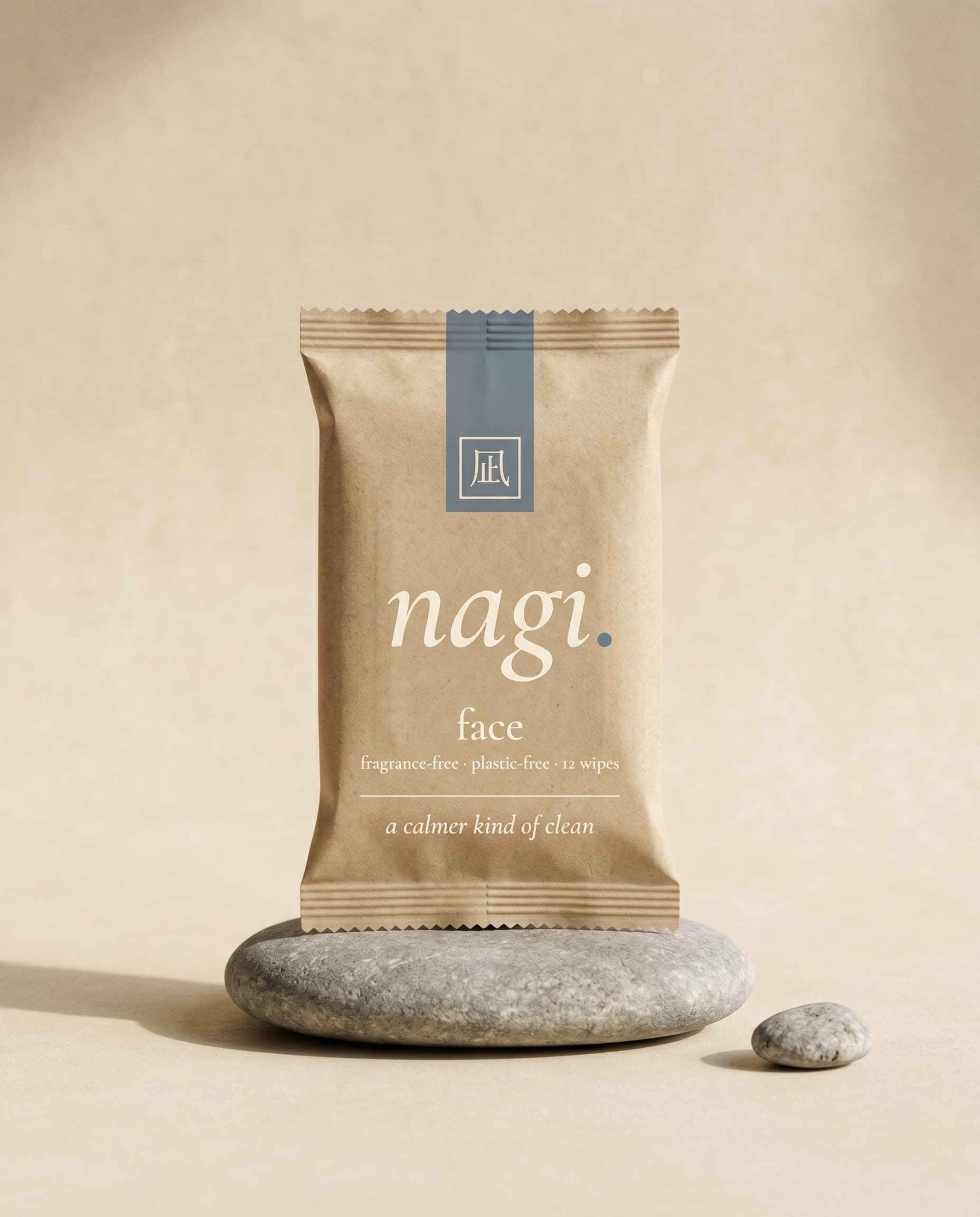nagi face — 100% cotton wipes, soft sealed sachet on a smooth river stone